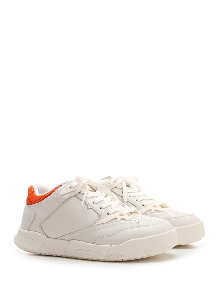 White sneaker with orange heel tab