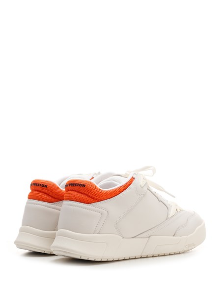 White sneaker with orange heel tab