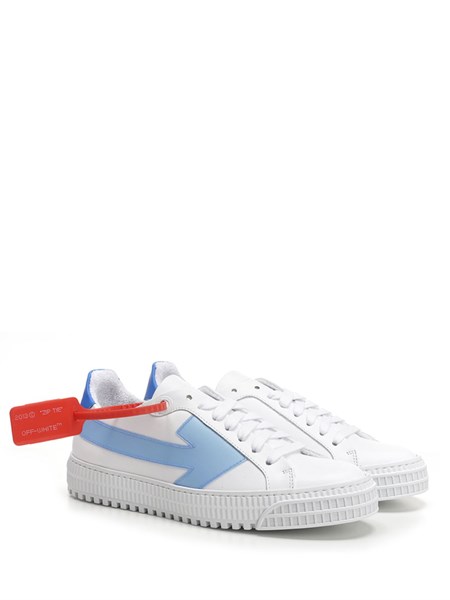 White sneakers with light blue arrow 